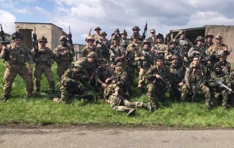 A group of airsoft players pose after a 40-hour event