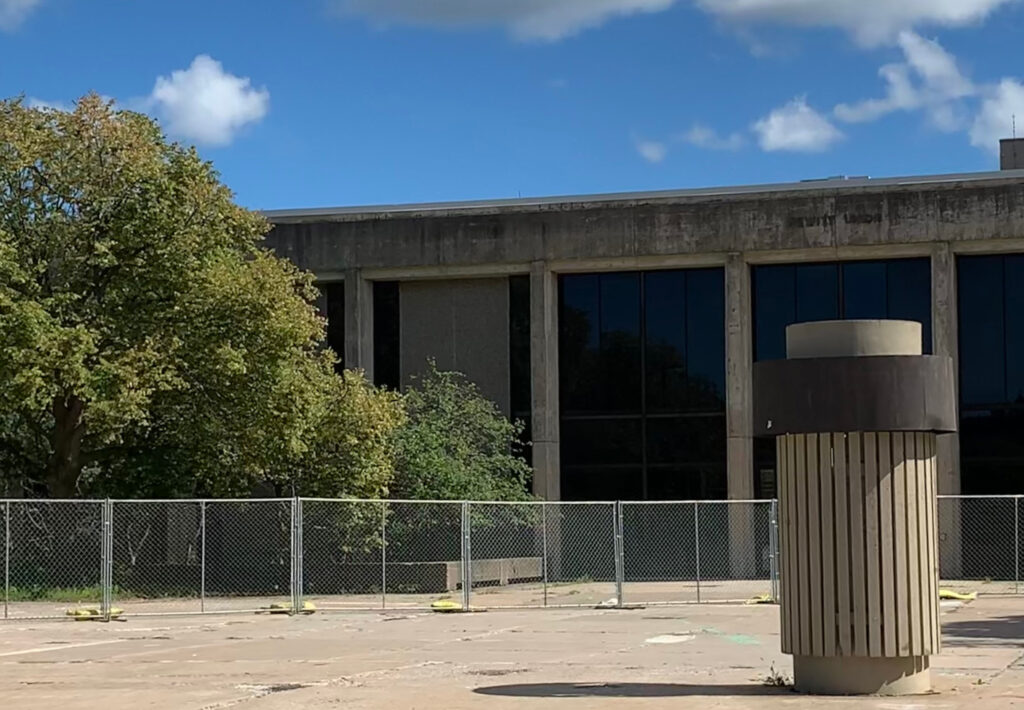 An image of Hewitt Hall surrounded by construction fences