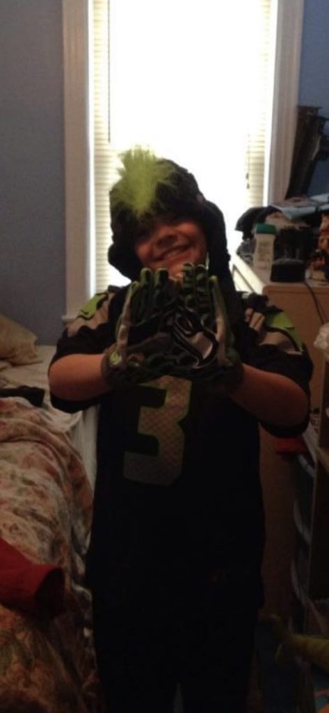 10-year-old Paul Baidy wearing Seattle Seahawks jersey, gloves and hat.