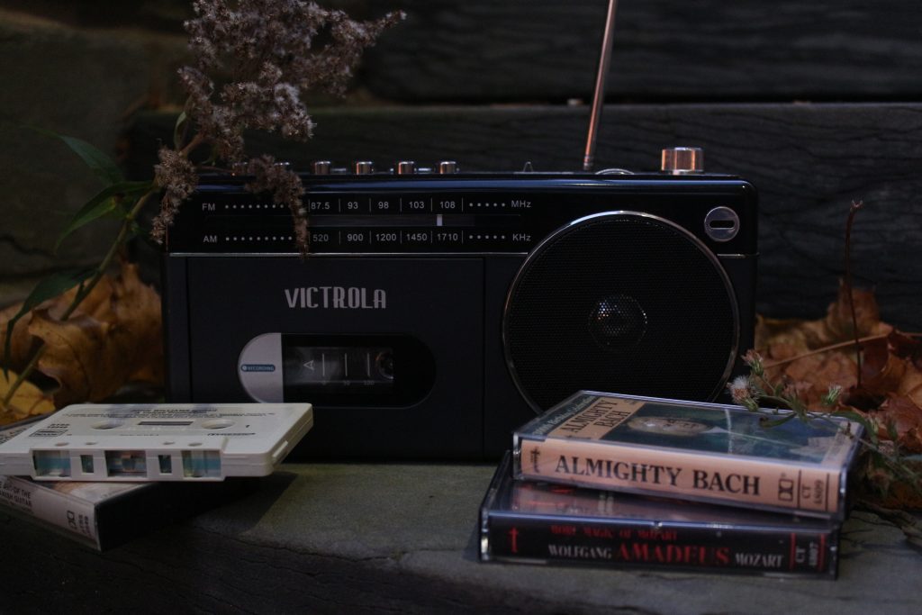 A photo of a cassette player surrounded by various cassettes.